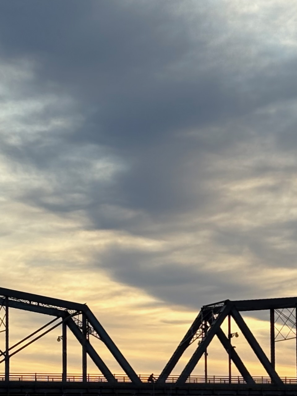 Biker crossing Alexandra Bridge, shot from the Canadian Museum of History